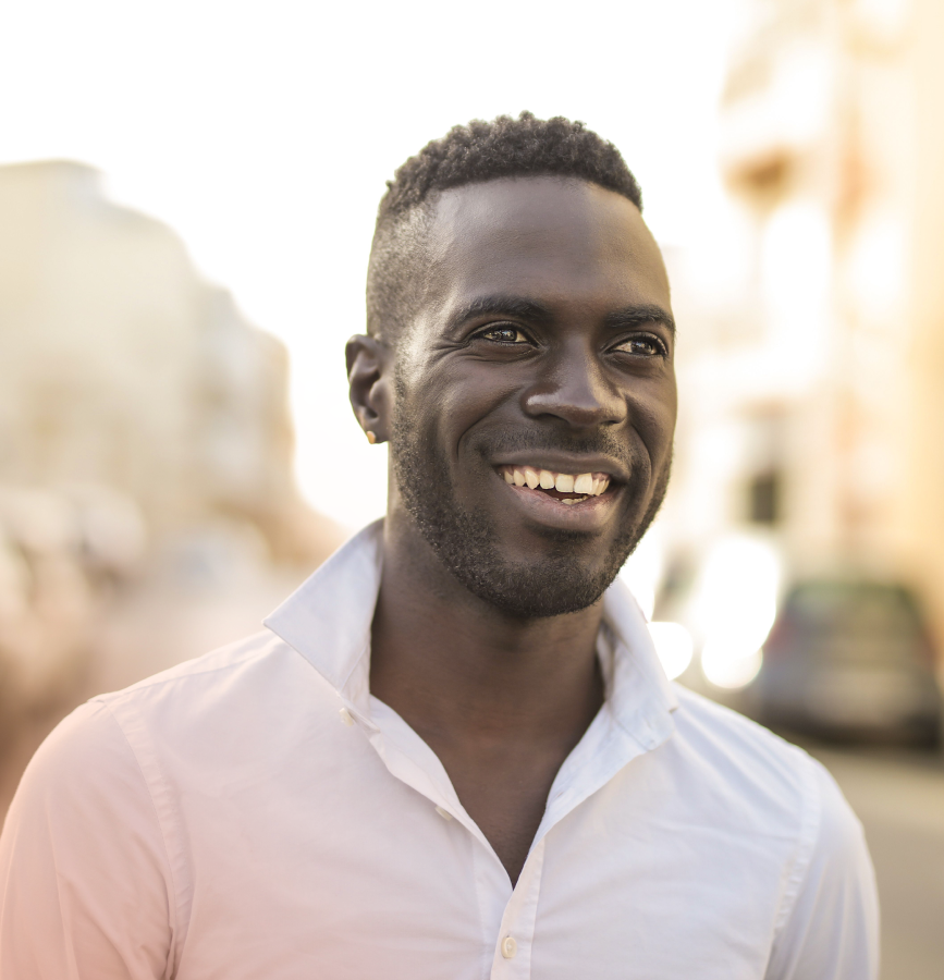 Man in white shirt with collar up smiling