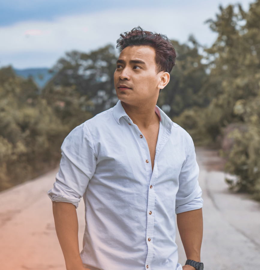 Decorative image: Man in light blue shirt standing outside